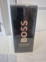 Front view of the sealed black box with gold text showing product name.