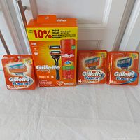 Photo showing the full set: Gillette Fusion 5 shave kit (razor handle, 2 cartridges, 7oz shave gel) and three sealed packages of Gillette Fusion Power replacement cartridges (8-pack and two 4-packs).