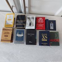 Photo showing all 10 packaged fragrance samples laid out in two rows on a white surface revealing brand names and sample sizes.