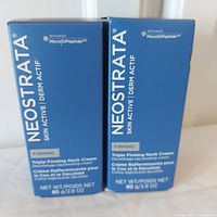 Two sealed blue boxes of Neostrata Triple Firming Neck Cream, each 80 grams.