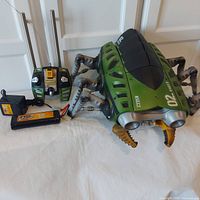 Full set including the handheld controller, battery pack, and charger laid out beside the toy for completeness