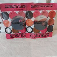 Two sealed Nudestix Stax Cloud Cushion Blush Balms in original packaging showing front side with product name and blush array.