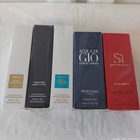 Front view of all five sealed fragrance boxes showing brand and model names.