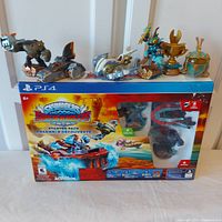 Skylanders Superchargers starter pack box with 3 character figures, 1 vehicle, trophy, and helmet figures on top