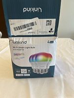 Box packaging showing Linkind brand and model info for 4-pack smart Wi-Fi light bulbs, A19 RGBTW, 800 lumens, 9.08W power, app remote control.