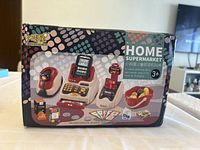 Front view of the toy supermarket set box showing all included items on the packaging graphics.