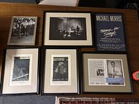 Overview of all six framed prints arranged on a table showing variety in subject and frame style