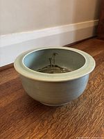 Front exterior of planter showing overall shape and pale blue glaze with horizontal ribbing.