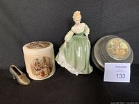 Photo showing the Royal Doulton figurine in green dress, the Sandland Ware marmalade jar with lid, the pot metal slipper, and the La Tosca jewelry box.