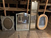 Four vintage mirrors in attic setting, showing size and shape variety.