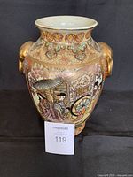 Full front view of hand-painted Japanese Satsuma porcelain vase showing traditional scene with figures, rickshaw, and floral decorations.