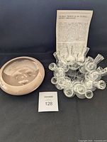 Haeger pottery beige round shallow bulb vase and vintage glass propagation station with multiple small bulb vials plus instruction sheet seen from front