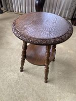 Table angled to show top surface detail and three legs