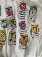 Assorted cards laid out showing Canucks, Blues, Sabres, Maple Leafs, Red Wings, Flyers, Golden Seals