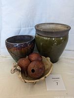 Overview of the three pottery pieces including the majolica jardiniere, green urn planter, and ceramic sheep bowl with dried fruit pods.
