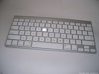 Top view of Apple wireless keyboard showing full key layout with white keys and aluminum frame.