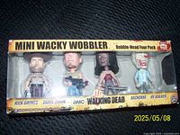 Front view of the boxed Mini Wacky Wobbler four-pack showing the four character figures.