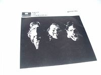 Front view of sleeve cover showing black background with white text and stylized faces of band members