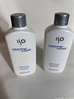 Front view of two new ISO Reviving Cleanse moisturizing shampoo bottles showing brand and product name.