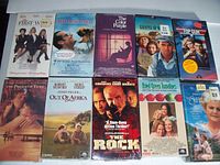 Photo of lot showing ten new sealed VHS movies arranged in two rows.