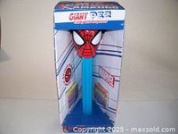 Front view of giant Spiderman PEZ candy roll dispenser in original Marvel packaging showing product design and branding.
