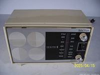 Front view of Zenith C412L vintage radio showing beige case, speaker grills, tuning dials, and frequency display with FM/AM bands.