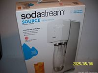 Front view of SodaStream Source Metal Edition starter kit box showing the soda maker image and features.