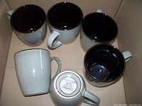 Five Sonoma coffee mugs arranged in a box, showing beige exterior and dark brown interior.