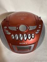 Top view of the Sony CFD-E75 showing control buttons, circular dial, and speaker grills.