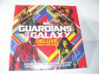 Front cover of Guardians of the Galaxy Deluxe Vinyl Edition featuring the movie's main characters in colorful geometric background with title and subtitle indicating deluxe vinyl edition.