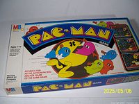 Classic Pac-Man board game box showing colorful Pac-Man characters and branding with Milton Bradley logo.