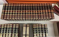 Full view of Funk & Wagnalls Encyclopedia volumes 1 to 20 lined up on a table, showing spine details.
