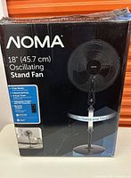 Box of NOMA 18 inch oscillating stand fan showing brand and product features