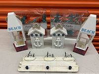 Photo showing all beach-themed patio lights and beach decor items including two lanterns, patio light sets, and wall hook rack.