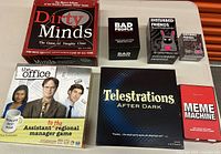 Full display of all six adult humor games arranged on a white surface.