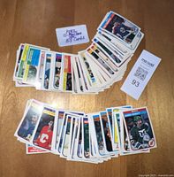 Collection of 1982 hockey cards laid out on a wooden surface, showing front of cards with player photos and team logos.