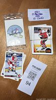 Photo showing some cards still in sealed plastic with a note indicating 1987 O-Pee-Chee NHL 61 cards.
