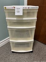 Front view of white plastic 4 drawer storage tower showing translucent drawers with Gracious Living label