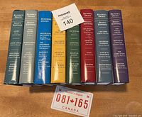 Front view of 10 Reader's Digest Select Editions books standing upright showing spines with titles and authors.