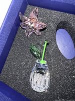Photo of pink crystal lily flower and clear crystal base with green stem piece in foam-lined blue box.