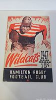 Front cover of the 1947 Hamilton Wildcats season program showing vintage illustration of a football player and title.