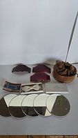 Full lot showing 3 Bakelite belt buckles, white Currie bowtie, 5 small mirrors, leather pouch and boxes