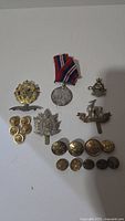 Group view of all military items including medal, cap badges and buttons
