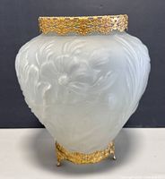 Front view of the 1930s satin glass vase with floral embossing and brass stand and rim visible.