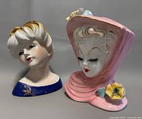 Two ceramic lady head vases shown side by side on grey background.