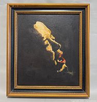 Full view of the framed original painting with visible detailed profile of face and signature.