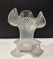 Front view of clear vintage RIEDEL ribbed glass vase showing ribbed pattern and flared top edges.