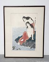 Framed woodblock print showing two women near water, overall view.