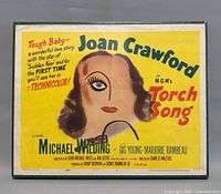 Full front photo of the Torch Song movie poster showing Joan Crawford's stylized portrait with bright yellow background and red and black text.