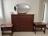 Full view of dresser with mirror and two side tables showing overall condition and style.